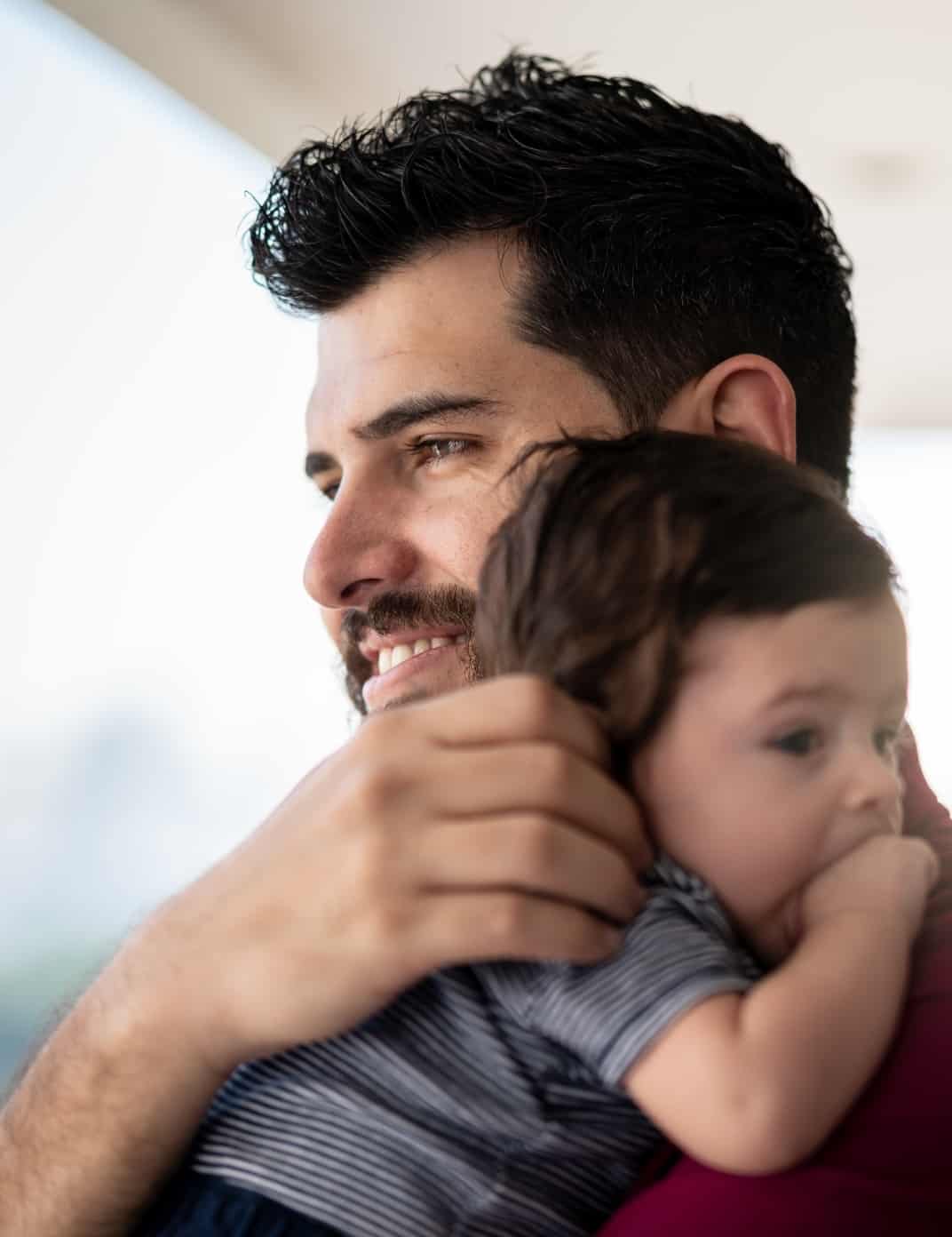 Diversified Roofing | man holding a baby