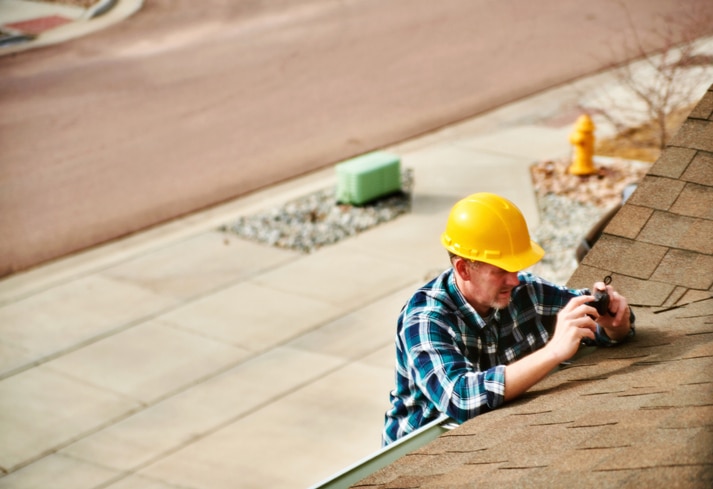 Roof Inspector surveying roof of property